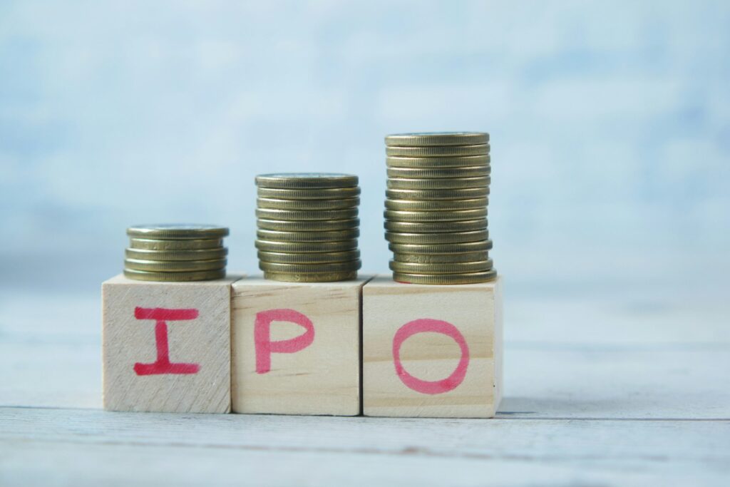 IPO text ,Initial Public Offering on wooden block with stack of coins